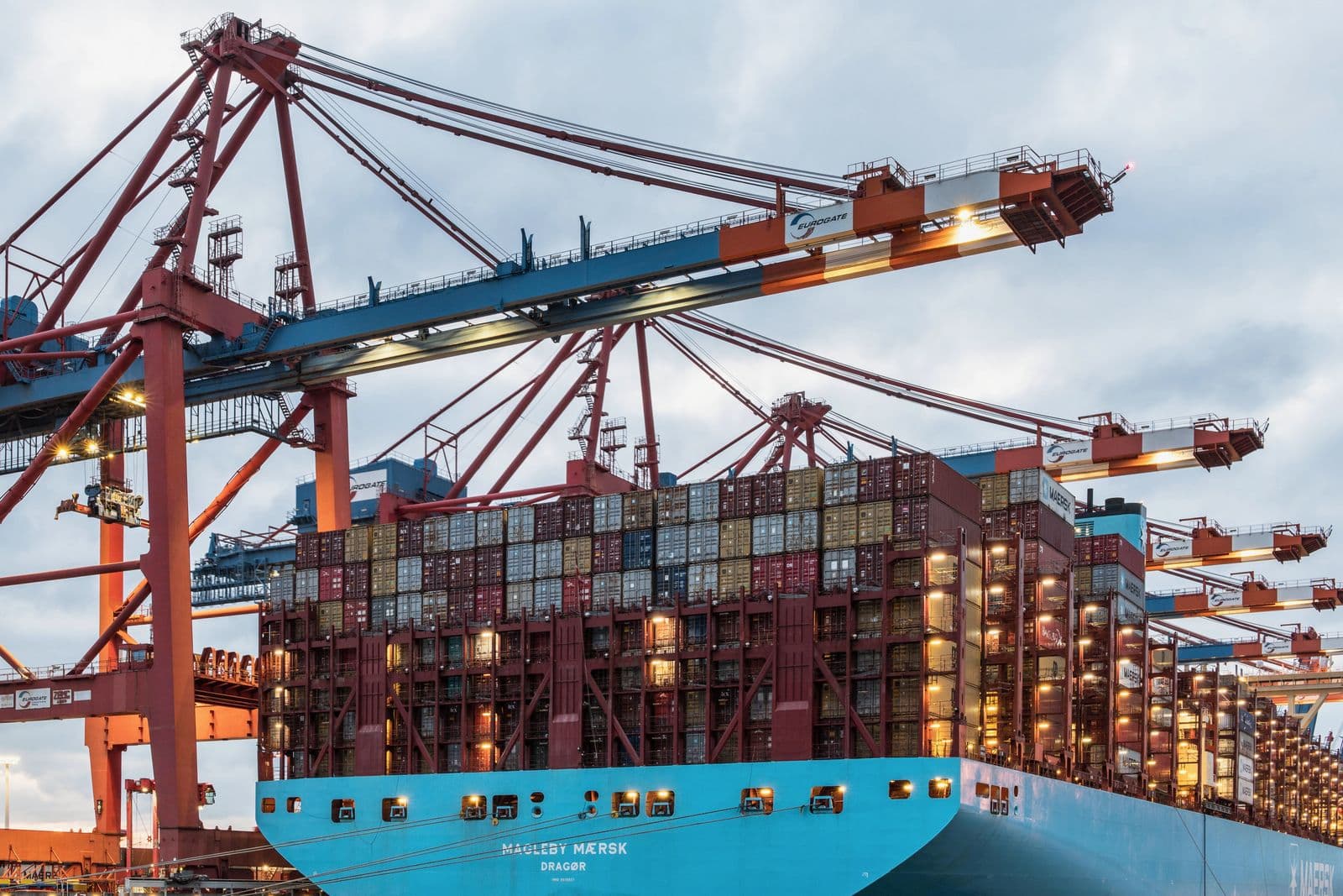 Port cranes working over a container ship